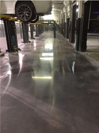 An image of beautiful polished concrete in a auto shop.